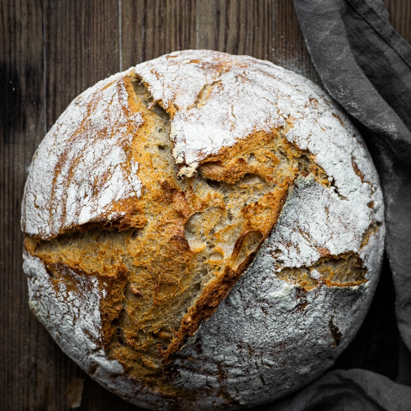 A round pain au levain sourdough loaf with a dark, scored crust